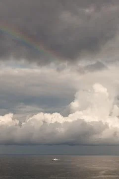 Lonely ship amid storm clouds in the sea Stock Photos
