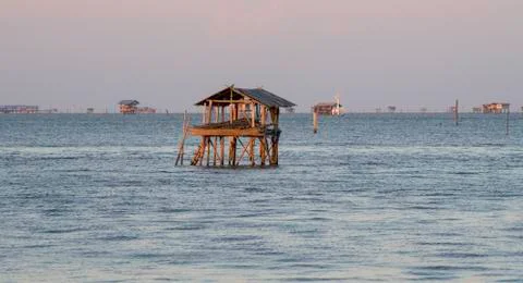Lonely small house without window and door in the sea Stock-Fotos