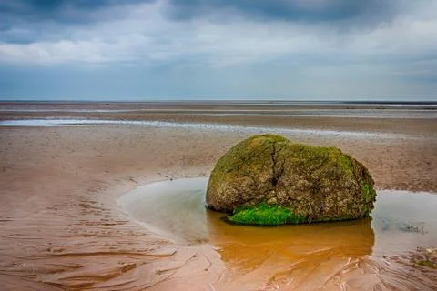 Lonely stone on the beach Stock Photos
