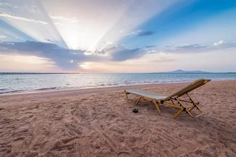 Lonely sunbed on beach Stock Photos