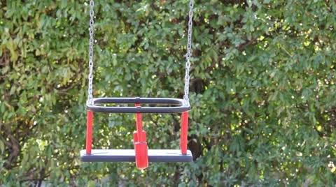 Lonely swing balancing in the park Video stock 12300420
