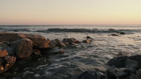 A lonely wave rolls over a stony shore Stock Footage 80530872