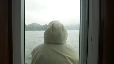 Lonely woman looking at the ocean from a boat in Halong Bay, Vietnam Stock Footage