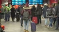 Lonely woman standing in waiting room and looking on train schedule, traveling HD Footage