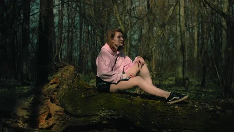 Lonely women is thinking hard while sitting on a tree in a summer forest, Stock Footage 165162821