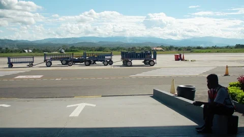 Lonely worker next to the Runway in a small airport Stock Footage 87776792