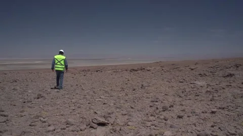 Lonely worker walking in the desert Stock Footage