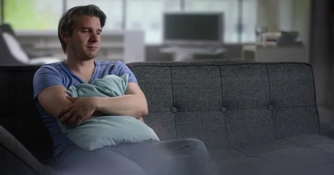 Lonely young man on a couch Stock Footage 78598298