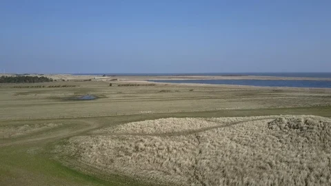 Long aerial sequence above North Sea coast fields Stock Footage 87315292