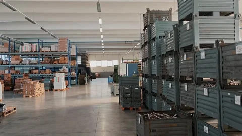 Long aisle between racks with containers in an industrial warehouse. Stock Footage 329320926