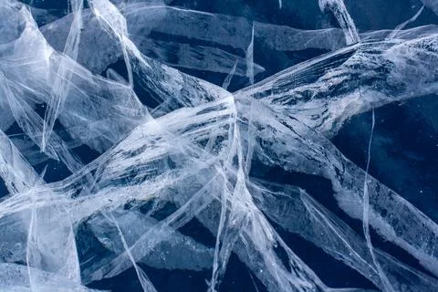 Long and deep cracks in the ice of Lake Baikal. Ice structure. Horizontal. Stock Photos