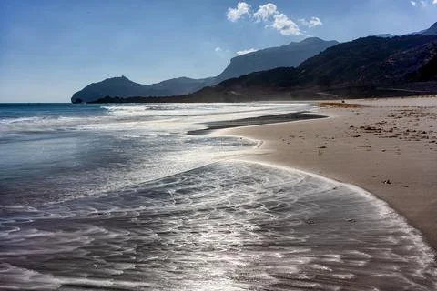 Long and empty beach. Arabian Sea, Oman. Stock Photos