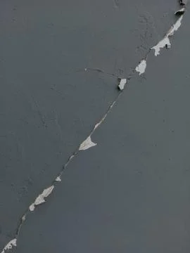 Long and narrow cracking, splitting in a wall. Stock Photos