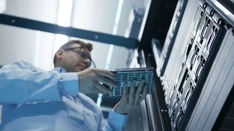 Long Angle Shot In Fully Working Data Center IT Engineer Installs Hard Drive  Stock Footage 74630793