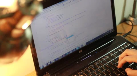 Long Angled Shot of Laptop with Changing Screen Stock Footage 49157379