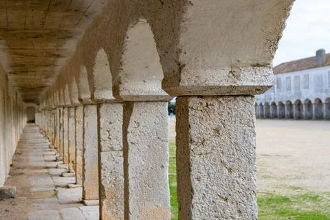 Long arcade corridor with repeating arches at Cabo Espichel Stock Photos