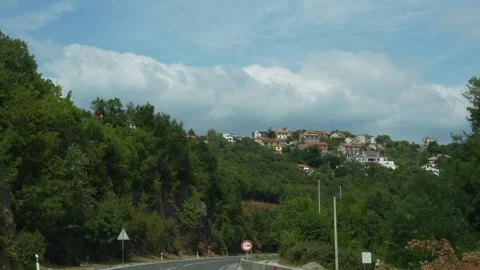 Long asphalt road stretching through Croatia rolling hills Stock Footage 299894963