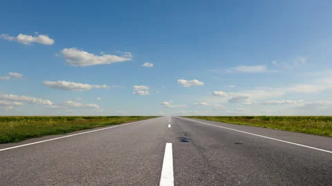 Long asphalt road under a cloudy sky, transportation travel time lapse scene Stock Footage 148837482