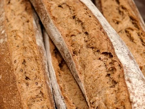 Long baguettes presented in the bread section of a supermarket, showcasing .. Stock Photos