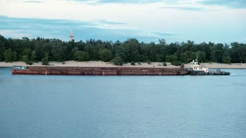 Long barge floating along the river at sunset Video stock 132194229