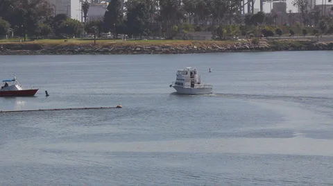 Long Beach Harbor cabin cruiser heading out Stock Footage