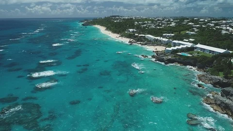 Long Bermuda Beach and Rocky Reef beside Coastal Homes Video stock 93287532