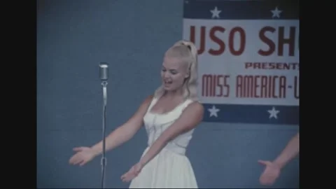 LONG BINH, VIETNAM - 1969: two performers share the microphone Stock-Footage 341323879