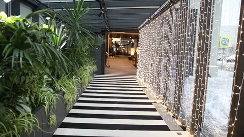 Long black and white empty corridor. Green flowers on the left side. 스톡 동영상 170796945