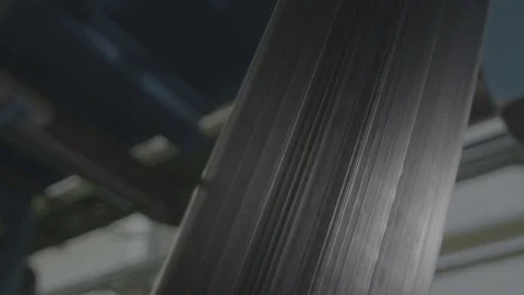 Long Black Tyre Flat Bar Moves up As Conveyor Closeup Stock Footage 84550656