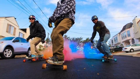 Long Boarding in San Francisco down a huge hill while holding smoke bomb in 4K.  Stock Footage 99316751