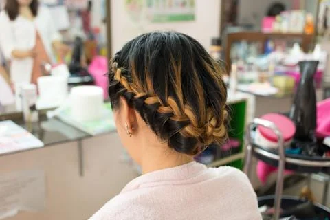 Long braid creative brown hair style in salon beauty Stock Photos