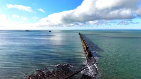 Long breakwater orbit to side view near Boulogne-sur-Mer, aerial Stock Footage 347177490