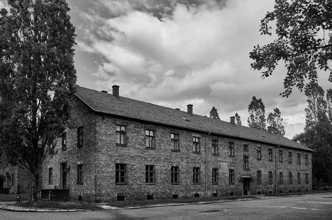 Long brick block barracks under cloudy sky in Auschwitz Stock Photos