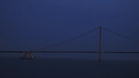 Long bridge with bright flashlights against navy night sky Stock Footage 113093835