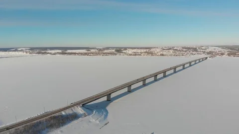Long bridge over the frozen river Stock Footage 101577243