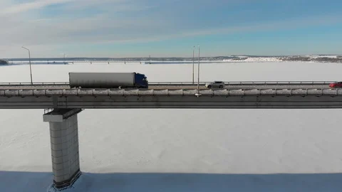 Long bridge over the frozen river Stock Footage 101577375