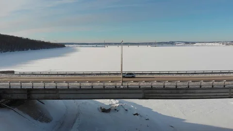 Long bridge over the frozen river Stock Footage 101577677
