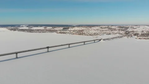 Long bridge over the frozen river Stock Footage 101577870