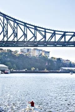Long bridge over the river next to buildings Stock Photos