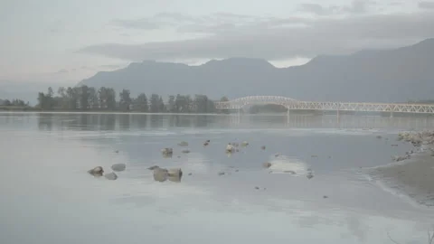 Long Bridge Spanning River Smooth Pan with Nature Stock Footage 164325813