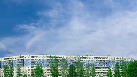 Long building under a blue cloudy sky Stock Footage 154047500