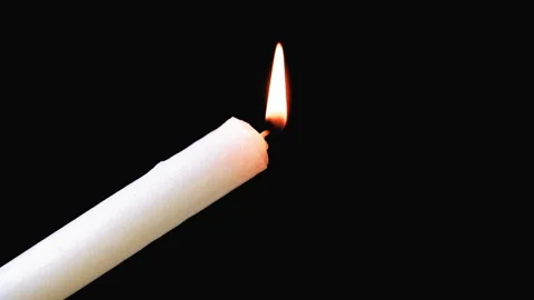 Long candle on a dark background. Видео 107781116