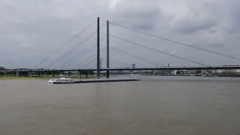 Long cargo ship with flag of the Netherlands floating slowly on the River Rhine Stock Footage 157314177