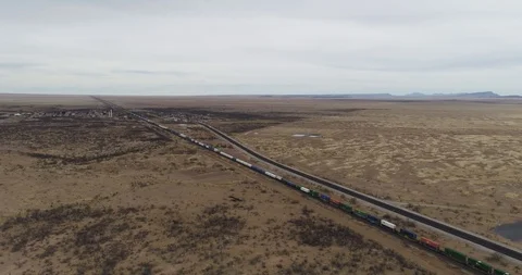 Long cargo train speeding along tracks through Texas landscape drone aerial 4K Stock Footage 111315348