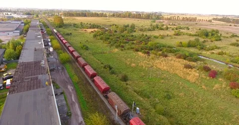 Long cargo train transporting wagons across the industrial district -14 Stock Footage 80330281