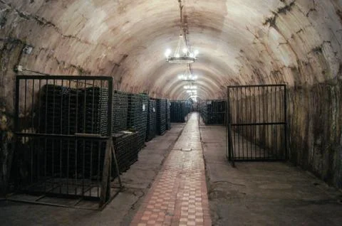 Long cellar with racks of bottles. Stock Photos