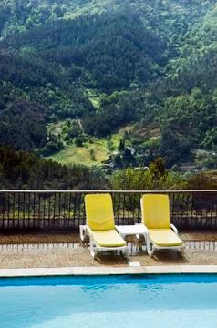 Long chairs by the pool 2 Stock Photos
