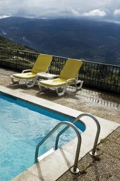 Long chairs by the pool 3 Stock Photos