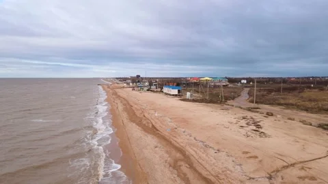 Long clean sandy beach with washing foamy waves upper view Stock Footage 217853222