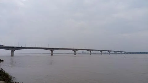 Long Concrete Bridge Spanning Over The Wide Expanse of Water Stock Photos
